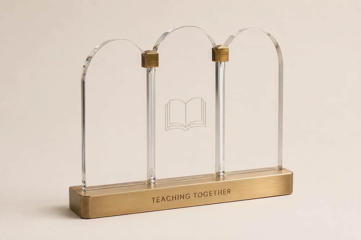 Interlocking acrylic arch teaching-team award on a brass base.