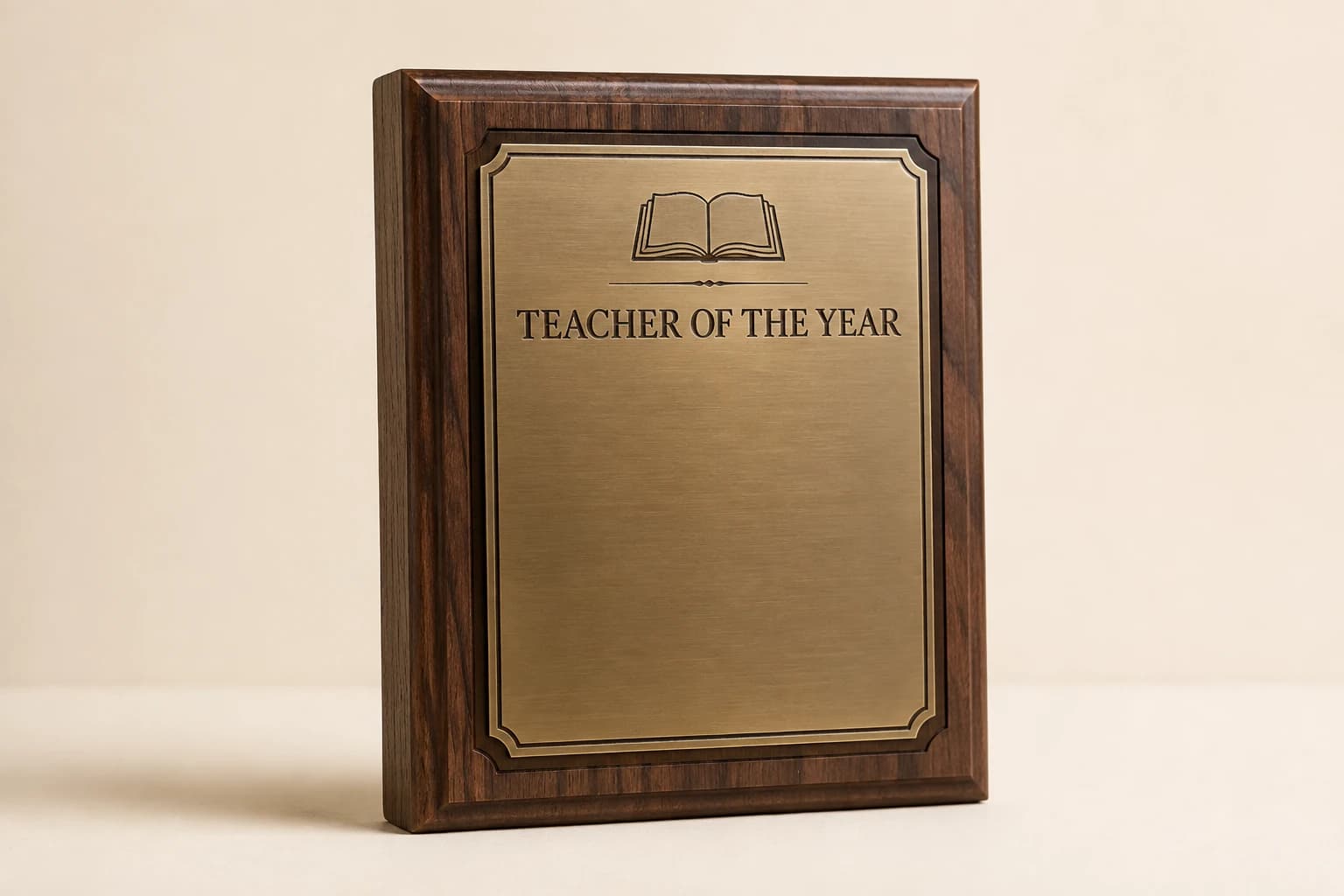 Walnut educator plaque with a brass plate and open-book engraving.